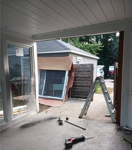 Old sliding patio door on a back porch in Grand Rapids, Michigan before replacement